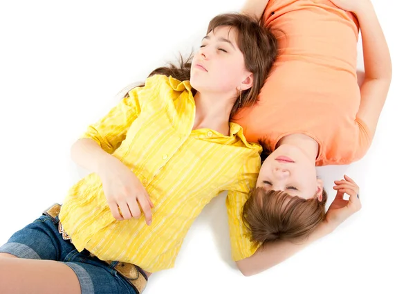 Two teen girls lie side by side — Stock Photo, Image