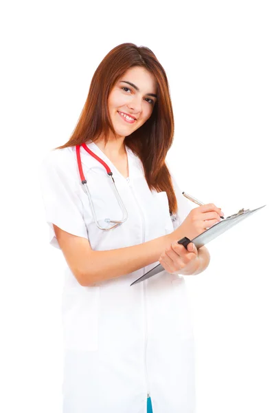 Young woman doctor writes — Stock Photo, Image