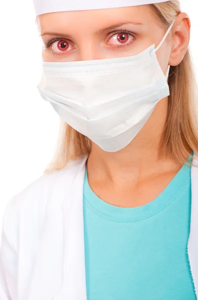 Gezicht van een jonge dokter in een beschermend masker — Stockfoto