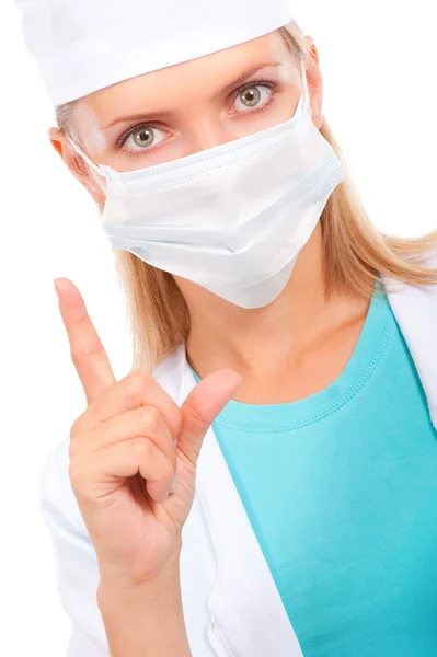 Jonge dokter in een masker waarschuwt — Stockfoto