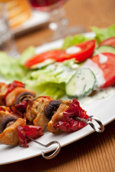 stock image Chicken meat on skewers and salad