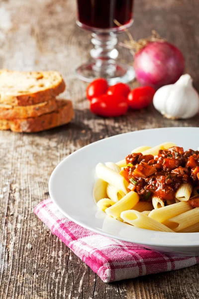 Penne bolognese and parmigiano cheese — Stock Photo, Image