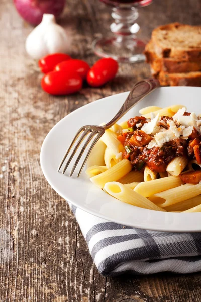 Penne bolognese and parmigiano cheese — Stock Photo, Image