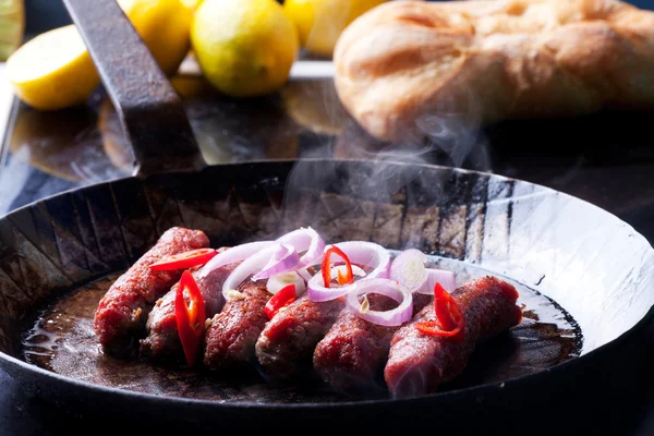 Cevapcici minced meat rolls in a pan — Stock Photo, Image