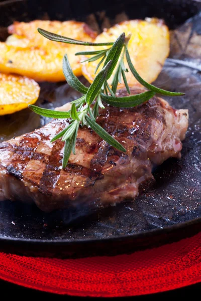 Closeup of a rosemary leaf on a steak — Stock Photo, Image