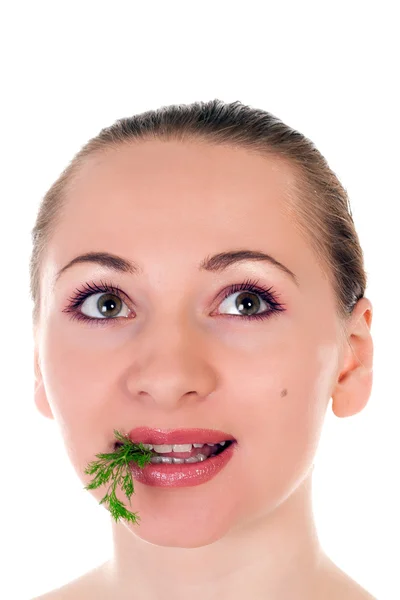 Stock image Young female model holding a batch of fresh green dill in her teeth