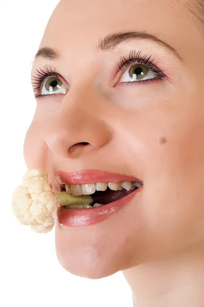 Young model with batch of cauliflower in her mouth — Stock Photo, Image