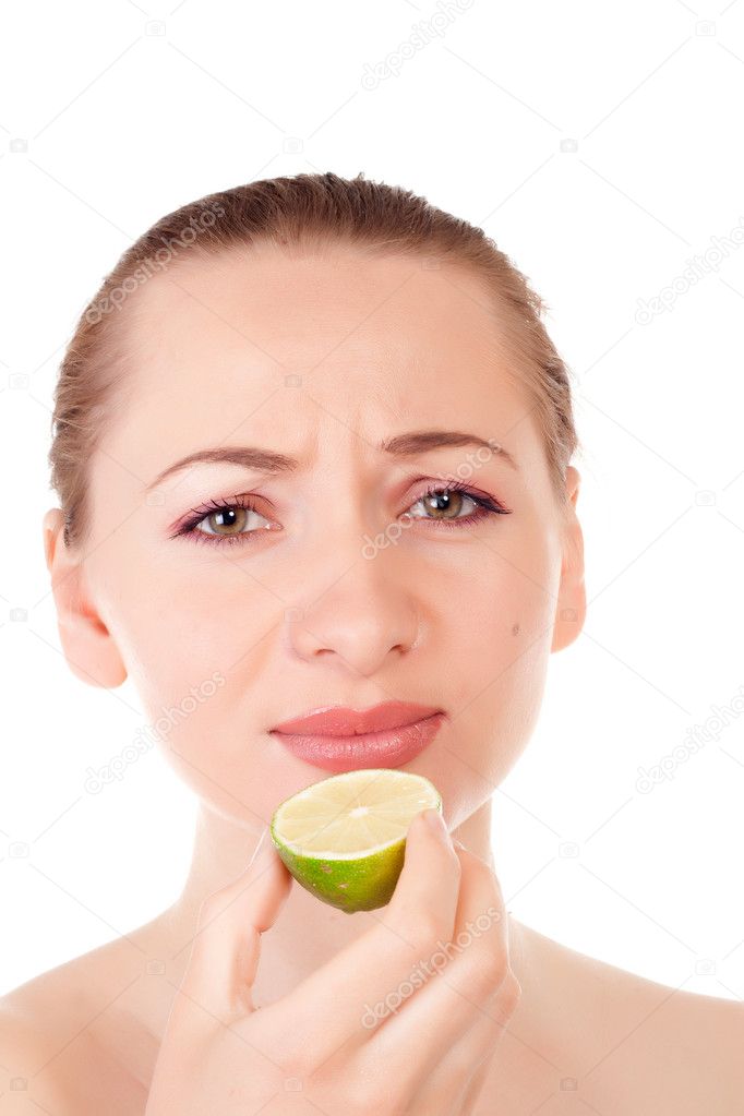 Pretty model posing with half of lime with a sour face