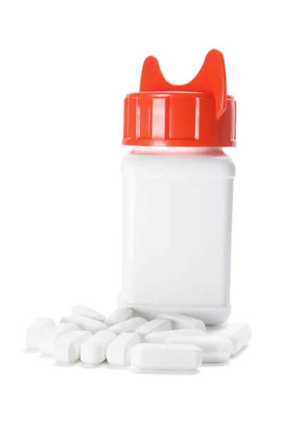 Таблетки і пляшка таблеток — стокове фото