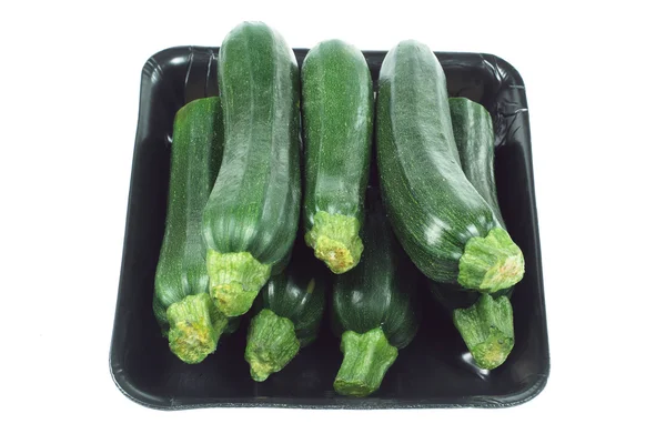 Zucchinis på frigolit bricka — Stockfoto