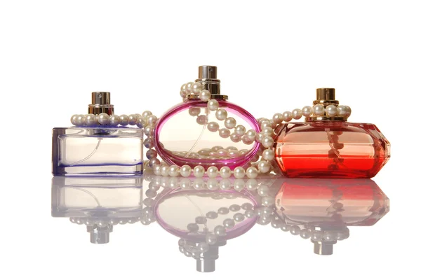 Perfume in a glass bottles and pearl beeds — Stock Photo, Image