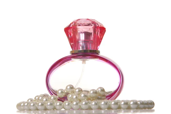 Perfume in a glass bottle and pearl beeds — Stock Photo, Image