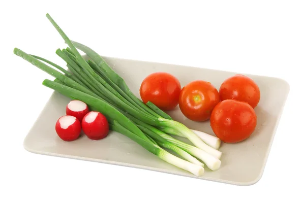 stock image White plate with tomato, radish and green onion