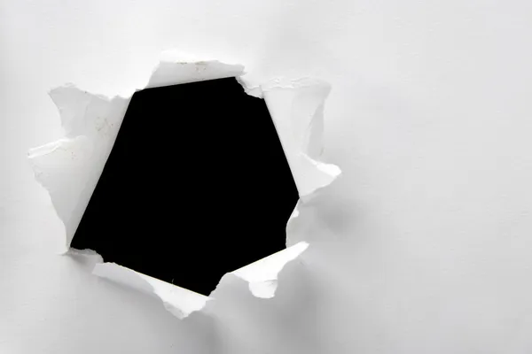 Hole in the white pape — Stock Photo, Image