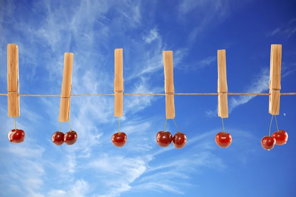 stock image Sweet red cherries and clothes line