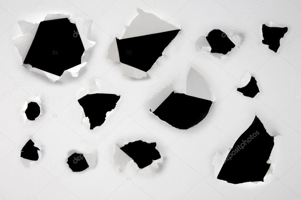 Closeup of a dark holes on white paper set