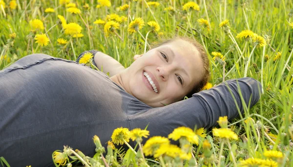 Mujer yace en un prado de flores —  Fotos de Stock
