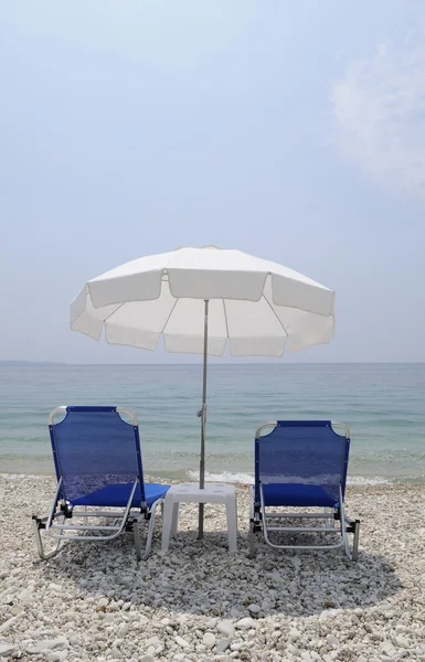 stock image Chairs and umbrella on the beach