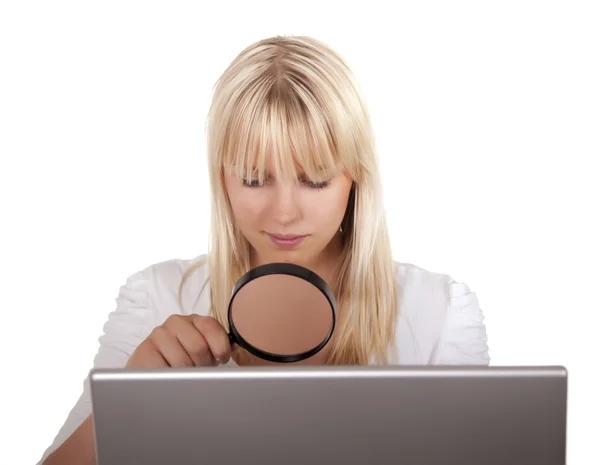 Kvinna med förstoringsglas och laptop — Stockfoto