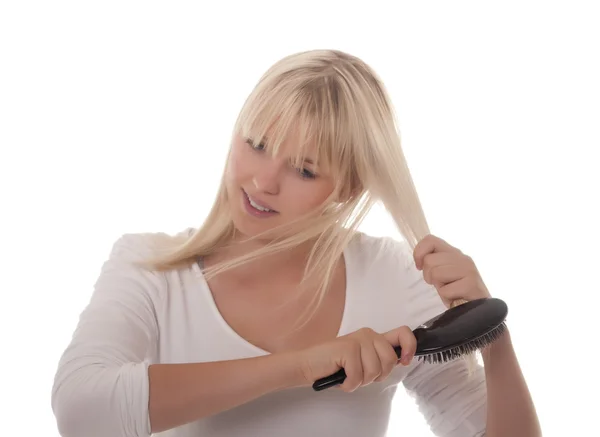 Young woman combing her hair — Stock Photo, Image