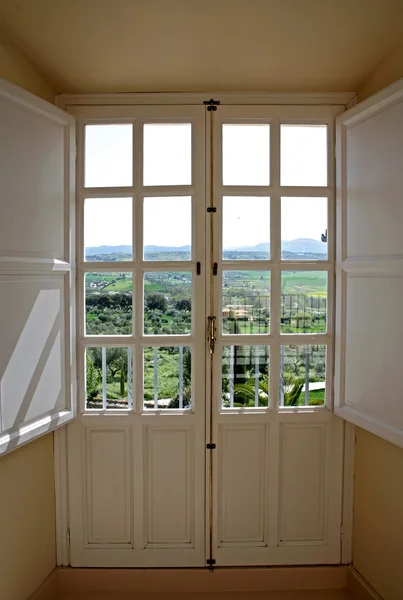 View through wooden doors to countryside — Stock Photo, Image