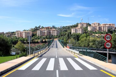 New road and bridge over golf course in Spain clipart