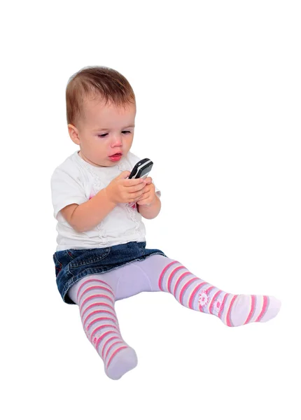 Young baby girl sending text messages on mobile phone — Stock Photo, Image