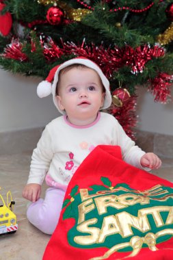 Girl toddler opening Christmas Presents clipart