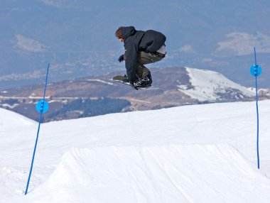 Man snowboarding on slopes of Prodollano ski resort in Spain clipart