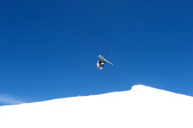 Somersault ski jump on slopes of ski resort in Spain clipart