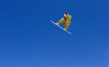 Huge snowboarding jump on slopes of ski resort in Spain clipart