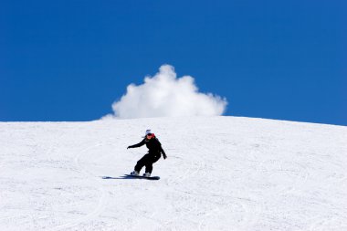 Woman snowboarding on slopes of Prodollano ski resort in Spain clipart