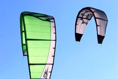 Kitesurfing Kites against a blue sky clipart