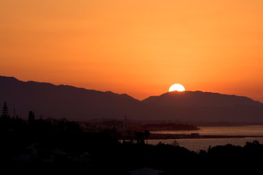 Golden sunrise over port of Marbella clipart