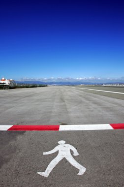 Symbol of walking man on runway at Gibraltar airport clipart
