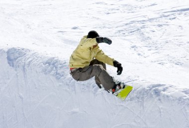 Snowboarder on half pipe of Prodollano ski resort in Spain clipart