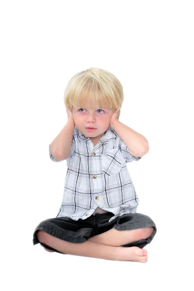 Young boy with his hands over his ears and white background — Stock Photo, Image