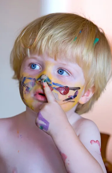 Young boy covered in face paint