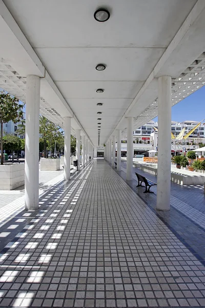 Fyra långa konvergerande linjer från inuti en gångväg i moderna squar — Stockfoto