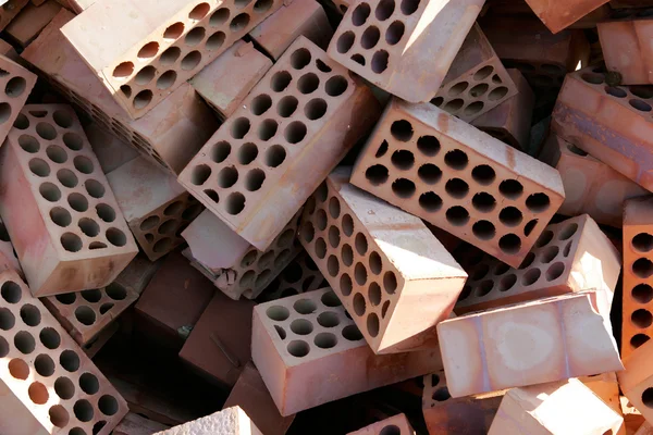 stock image Pile of red bricks with cirlces or holes