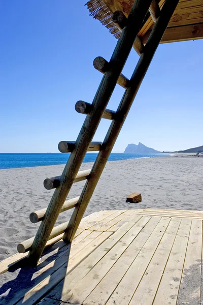Rock of Gibraltar seen thourgh ladder on Spanish beach — Stock Photo, Image