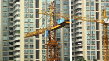 Building of a skyscraper with two tower cranes clipart