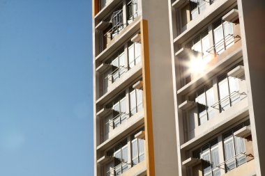 New apartments building and blue sky as a background clipart