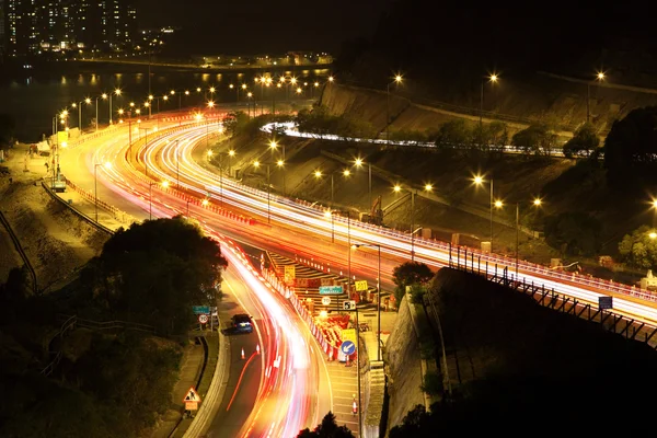 stock image Road with car traffic at night and blurry lights showing speed a