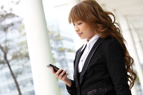 Beautiful business woman on the phone at modern building — Stock Photo, Image