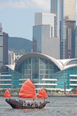 Sailboat sailing in the Hong Kong harbor clipart