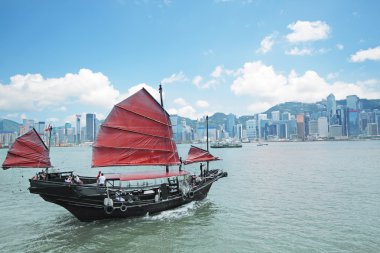 Junk boat with tourists in Hong Kong Victoria Harbour clipart