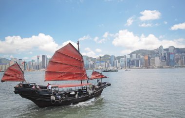 Junk boat with tourists in Hong Kong Victoria Harbour clipart