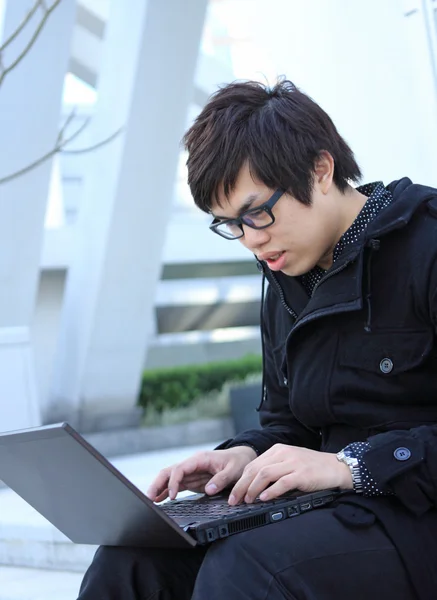 Asian man using notebook — Stock Photo, Image