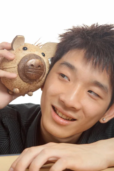 Asien mann mit sparschwein — Stockfoto